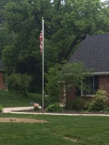 A house with a US flag on a flagpole